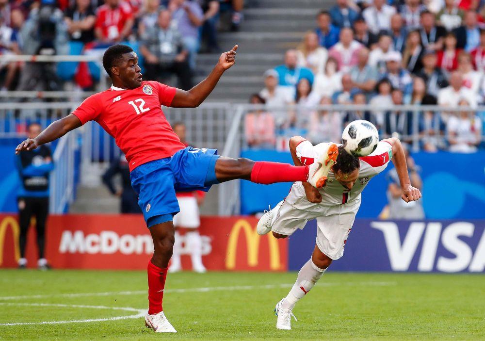 Duško Tošić izbacuje loptu glavom ispod noge Kembela  