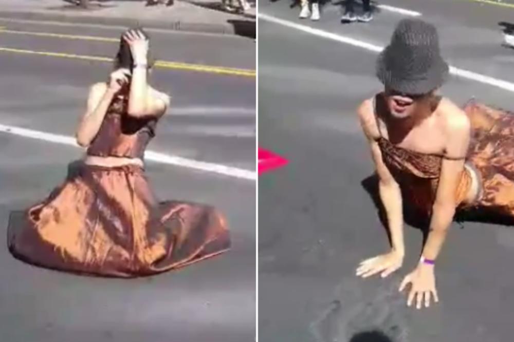 PRLJAVI PLES NA VRELOM BEOGRADSKOM ASFALTU: Ovaj učesnik Prajda je obukao haljinu, pa se BACIO NA BETON i počeo da LOMI KUKOVIMA (VIDEO)