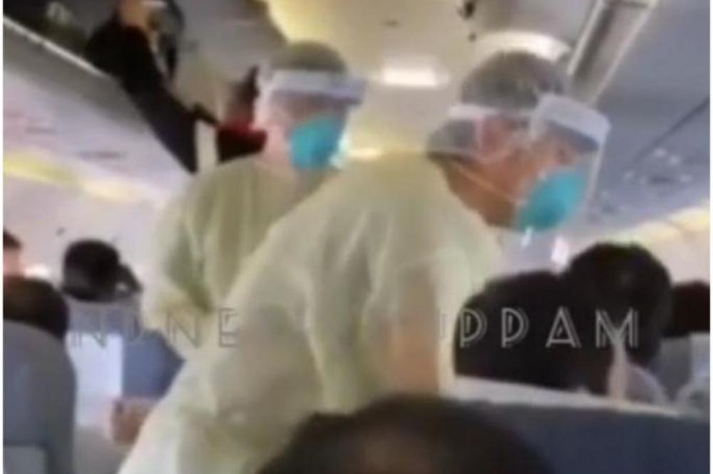 PANIKA ZBOG OPASNOG VIRUSA KOJI NAPADA PLUĆA: U avionu lekari u zaštitnim odelima kontrolišu putnike (VIDEO)