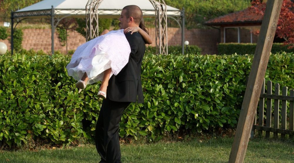 Mladoženja drži mladu u naručju / ilustracija